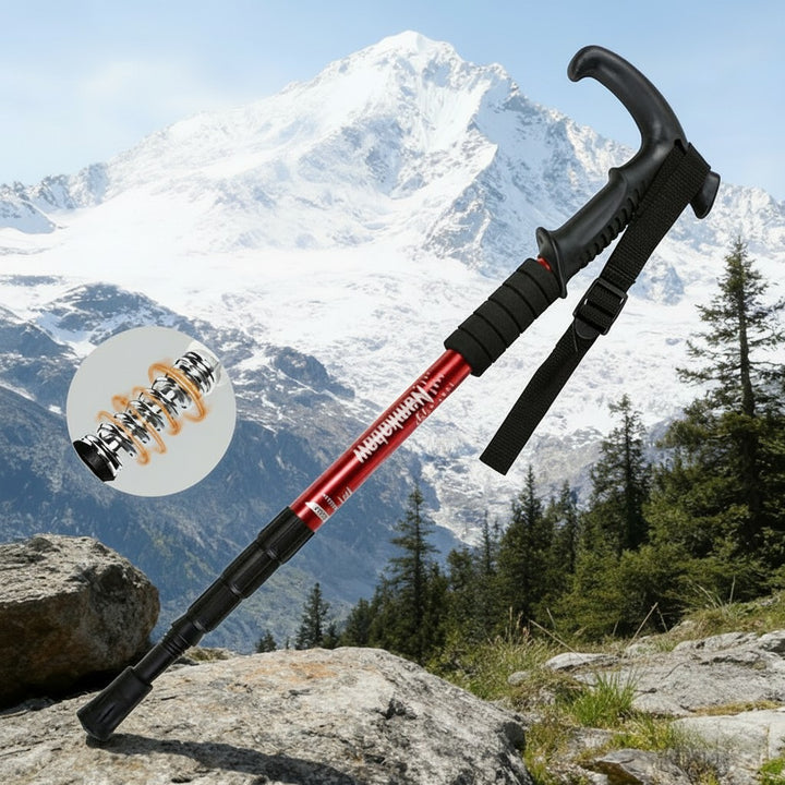red aluminum telescopic hiking pole with black ergonomic grip and anti-shock system, set against a snowy mountain backdrop.